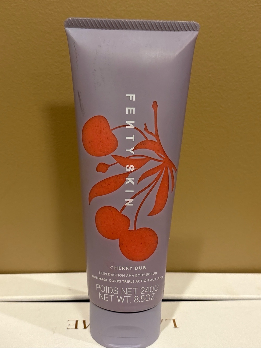 Fenty Beauty Lavender Tube with Orange Cherry Graphic
